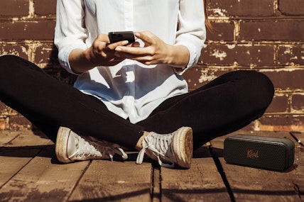 Klipsch Nashville on deck beside person with phone 2000x1333