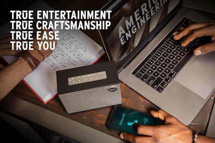 A Klipsch Heritage Groove tabletop stereo next to a computer